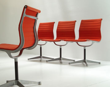 FOUR ALUMINIUM GROUP CHAIRS BY CHARLES AND RAY EAMES